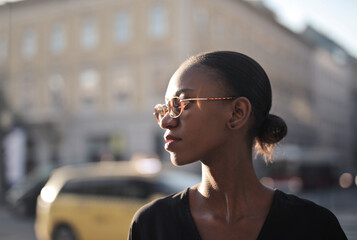 portrait profile of  a black woman in the street