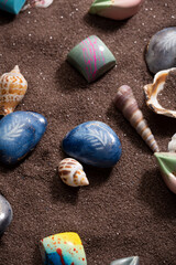 Overhead view of chocolate candies on brown sand