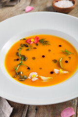 Yellow Pumpkin Soup on wooden table