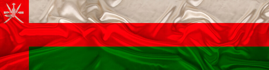 long panorama of the national flag of the United Arab Emirates state on beautiful silk, the concept of tourism, emigration, economy, politics, civil rights and freedoms