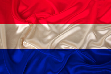 national flag of the country Holland on gentle silk with wind folds, travel concept, immigration, politics, copy space, close-up