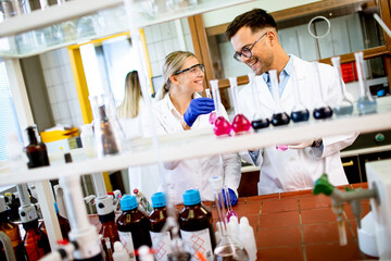 Group of young researchers analyzing chemical data in the laboratory