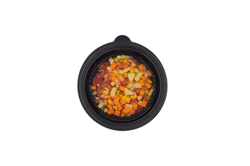 proper healthy diet
top view isolated white background, vegetable soup with carrots green peas, zucchini and tomatoes