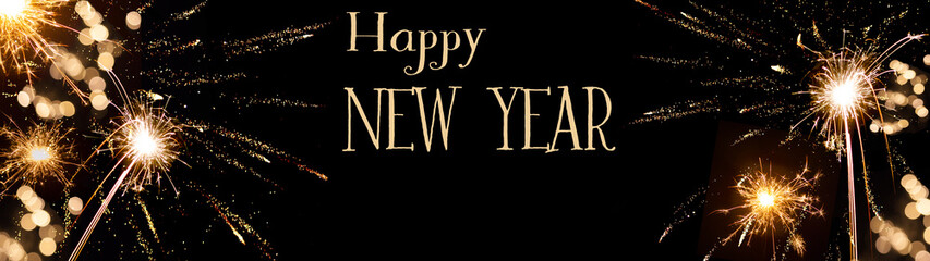 Obraz premium Happy New Year background banner panorama - sparklers firework and bokeh lights on black night texture, with space for text