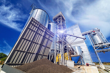 Industrial zone with steel grain elevators. Crop storage in tanks. Selective focus.