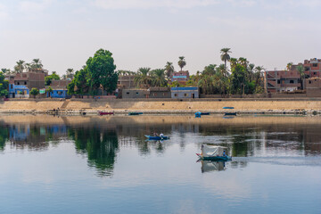 Traditional Egyptian villages on the bank of the river Nile. Views sailing on the cruise on the river Nile from Luxor to Aswer, Egypt