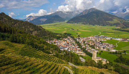 Aerial view of the historic center of Burgusio, Malles,  and the Prince's Castle, Val Venosta, South Tyrol, Italy