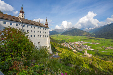 Aerial view of the historic center of Burgusio and the Benedictine Abbey of Monte Maria (Abtei Marienberg), Bolzano province, South Tyrol, Italy.