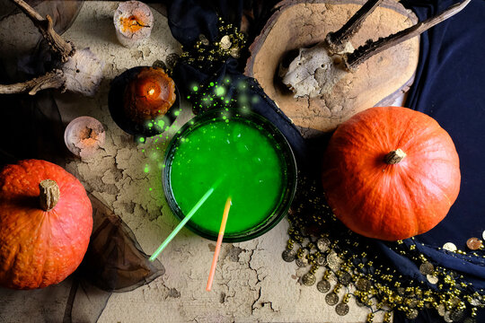 fortune-teller's table, witches covered with a black cloth, pumpkins lie, animal skulls, green witch's potion, candles are burning, the concept of Halloween, love spell, clairvoyance