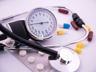 Tonometer and pills on a white background.Medicine and health concept