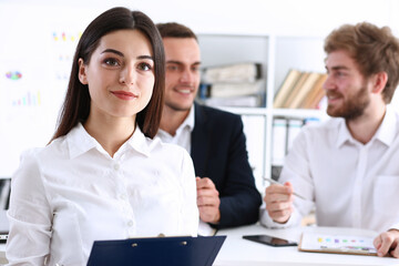 Beauty Businesswoman holding clipboard with paper fo notes on backround two peoples smiling aducation and discussing