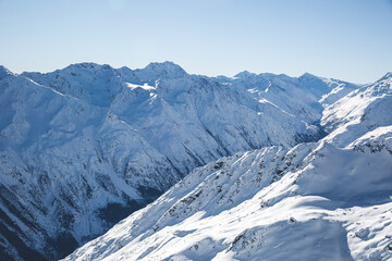 Fototapeta na wymiar Blue sky and snowy mountains peak view. Panorama of winter Alps mountains in Solden,Tirol, Austria. copy space