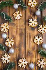 Christmas  composition with gingerbread snowflakes on the  wooden  background. Location vertical.