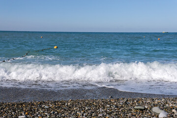 sea water with small waves close-up selective focus. Rocky beach with sea water. static video