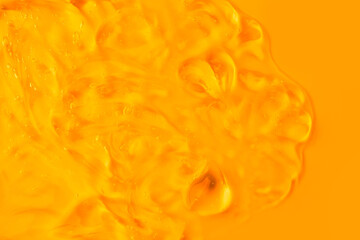 Cream gel cosmetic lubricant . Transparent smudge yellow orange. The texture of gel cream. A sample of a cosmetic product.