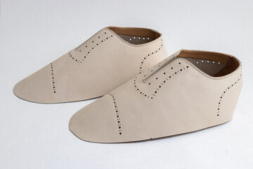 Shoe blank made of pieces of smooth light leather with perforations near the lacing and on the...