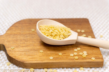 Macaroni stars. Star shaped noodles. Italian pasta for soup, stelline. close up