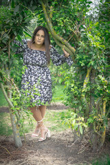 Mixed Race, Plus Sized Model Looking Through Natural Archway