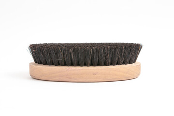 medium brush with stiff bristles and wooden handle for shoe care