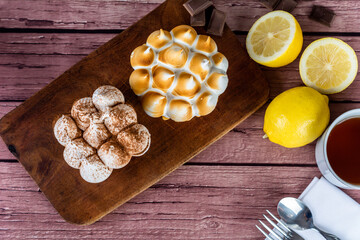 Mini chocolate and lemon pie cake with cup of tea.