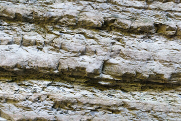 background layers in sedimentary rock on cliff face. Cliff of rocky mountain. Rock skate in the mountain. texture