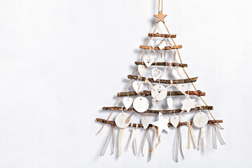 Zero waste christmas with alternative handmade xmas tree hanging over light wall