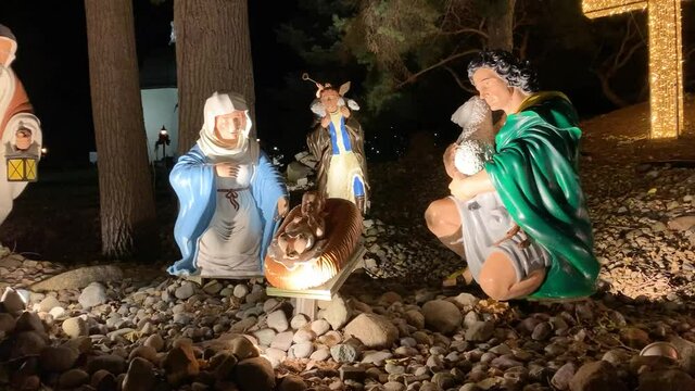 Life size Mary and Joseph looking over Jesus in awe with shepherd, animals, and wise men in background at Bronner's Nativity Scene in Frankenmuth, Michigan.