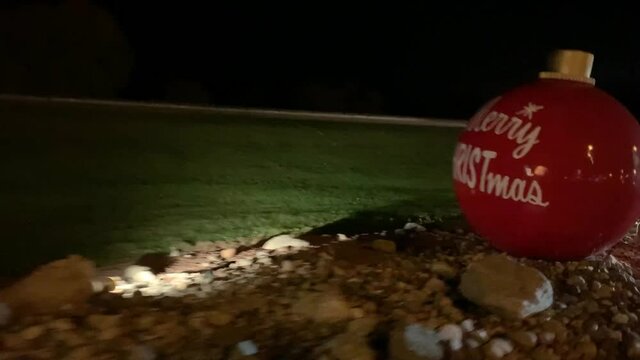 Passing By A Huge Red Ornament At Bronner's Christmas Wonderland In Frankenmuth, Michigan.