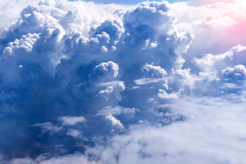 Beautiful blue sky above clouds with warm sunlight view from plane