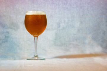 A glass with beer on colorful background