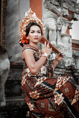 Fototapeta na wymiar Local Balinese girl in their beautiful traditional clothing at temple.