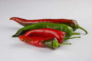 four colored peppers green and red isolated on white