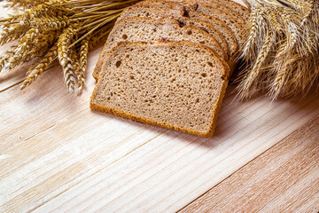 Traditional bread. Fresh loaf of rustic traditional bread with wheat grain ear or spike plant on...