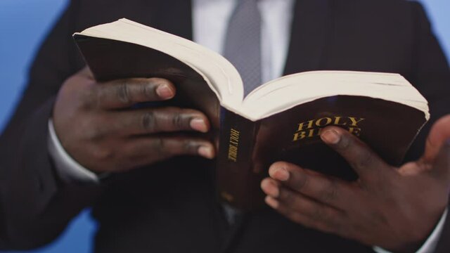 Christian black church father reading holy bible closeup