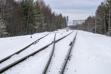 Railway in winter. Snow-covered railway tracks.