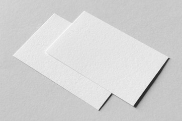Textured business card mockup on a grey background.  85x55 mm.