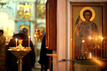 Candles in a gold candlestick in front of the altar in an Orthodox church. Altar of the Orthodox...
