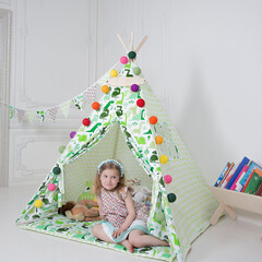 child playing with toys in teepee © Alexander