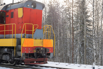 Train in winter. Old diesel locomotive on the railway.