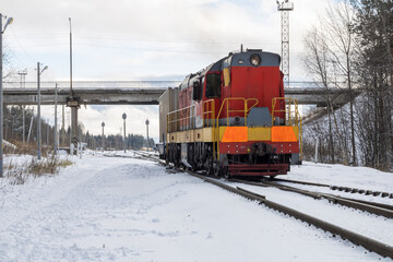 Train in winter. Old diesel locomotive on the railway.