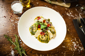 Black Angus hand-made dumplings. Cucumber-julienne with chilli-garlic butter or beef stock with sour cream. Delicious meat food closeup served on a table for lunch in modern cuisine gourmet restaurant