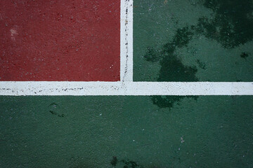 Top view of volleyball or tennis court. White lines and red and green ground. Sport field ground background.