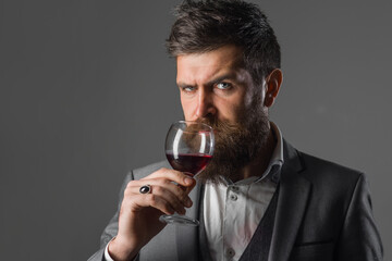 Wine degustation. Bearded man with glass of wine. Tasting alcohol.. Bearded man with alcohol. Man in suit drinks wine. Alcohol. Wine. Man with Bordeaux.
