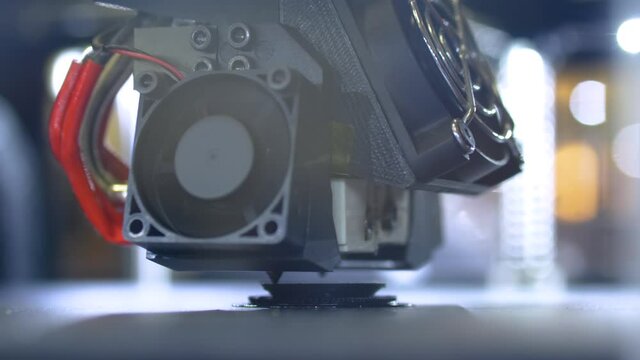 3D printer prints physical 3D model with plastic wire filament at modern technology exhibition, factory - close up. Additive technologies, science, prototyping, futuristic concept