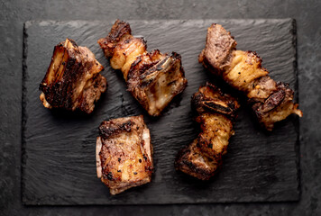 grilled beef ribs on a stone background