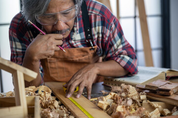 carpenter is selecting wood for making furniture, wooden handcraft working at home