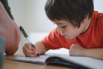 Cropped shot father helping his boy with homework, Dad and Son doing homework together, Teacher...