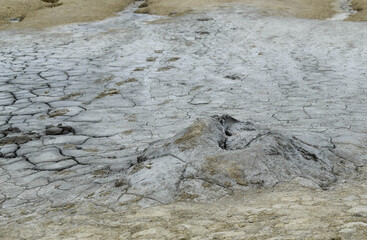 Landscape with cracked soil from Mud Volcanoes, at Paclele Mari, Romania. Volcanic rocks and lava of mud volcanoes. Lunar landscape in Europe