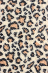 Leopard skin design on fabric texture. Abstract textile background.