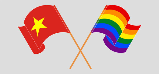 Crossed and waving flags of Vietnam and LGBTQ.